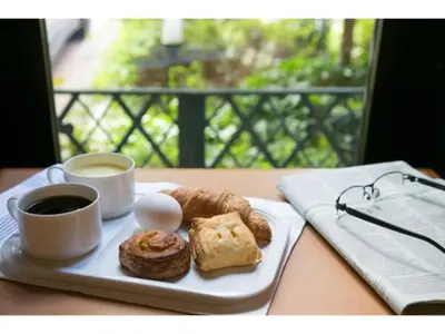 a plate of pastries and two cups of coffee on a table at R&B HOTEL HIGASHI NIHONBASHI - Vacation STAY 14016v in Tokyo