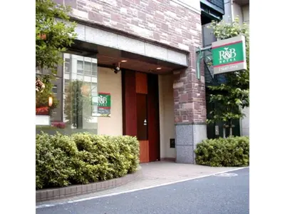 a front of a building with a red door and bushes at R&B HOTEL HIGASHI NIHONBASHI - Vacation STAY 14012v in Tokyo