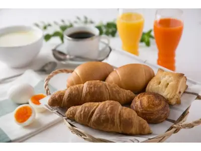 a plate of bread and croissants on a table at R&B HOTEL HIGASHI NIHONBASHI - Vacation STAY 14017v in Tokyo