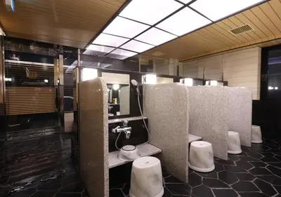 a bathroom with a row of sinks and toilets at APA Hotel Ueno Ekimae in Tokyo