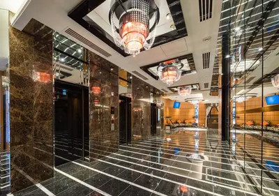 a lobby of a building with marble floors and a chandelier at APA Hotel Ueno Ekimae in Tokyo