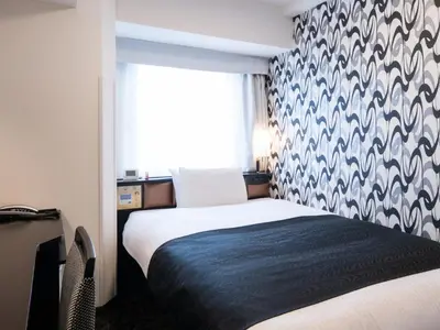 a bedroom with a bed and a window at APA Hotel Ueno Ekimae in Tokyo