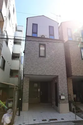 a brick building with a garage in the middle at Wonderful stay TOKYO nakanoshinbashi in Tokyo
