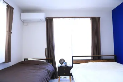 a bedroom with two beds and a window at Wonderful stay TOKYO nakanoshinbashi in Tokyo