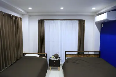 two beds in a room with a window at Wonderful stay TOKYO nakanoshinbashi in Tokyo