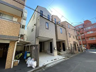 a group of buildings on a street with trash bags at Wonderful stay TOKYO nakanoshinbashi in Tokyo