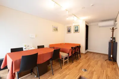 a meeting room with two tables and chairs in it at Annekaffeekanne in Tokyo