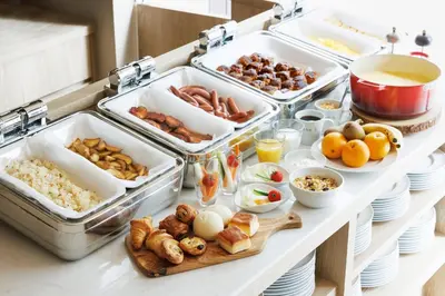 a buffet with many trays of food on a table at the b ginza in Tokyo