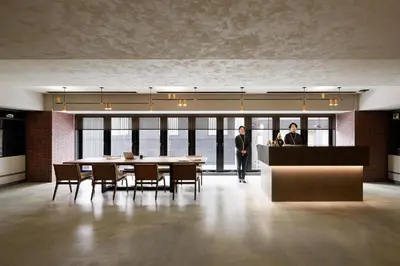 two men in a room with a table and chairs at the b ginza in Tokyo