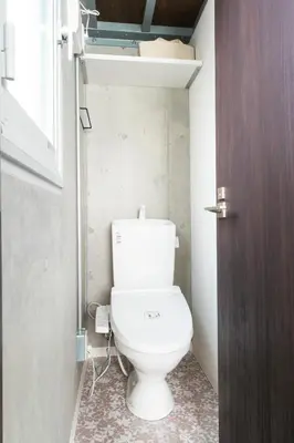 a bathroom with a toilet in a small room at Oyado danran \u56e3\u6b12 in Tokyo