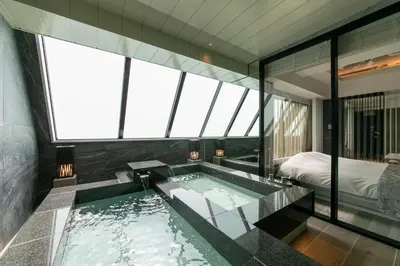 a bathroom with a jacuzzi tub in a room with windows at Hotel Karuta -Love hotel in Tokyo