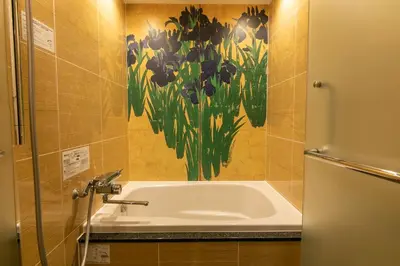 a bathroom with a sink and a painting of flowers at Hotel Karuta -Love hotel in Tokyo