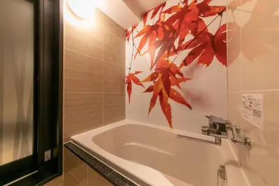 a bathroom with a white tub with a leaf on the wall at Hotel Karuta -Love hotel in Tokyo