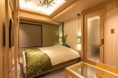a small bedroom with a bed and a window at Hotel Karuta -Love hotel in Tokyo