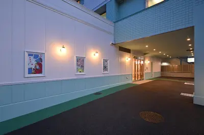 a hallway of a building with paintings on the wall at Four Stories Hotel Maihama Tokyo Bay in Urayasu