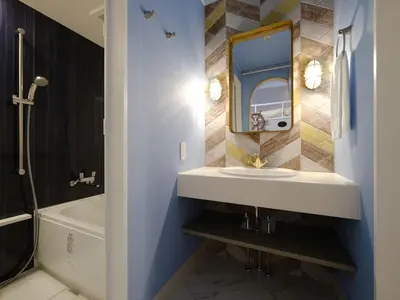 a bathroom with a sink and a tub and a mirror at Four Stories Hotel Maihama Tokyo Bay in Urayasu