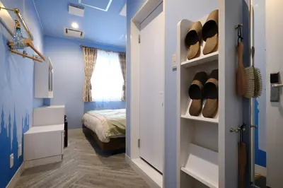 a room with a bed and a closet with shoes at Four Stories Hotel Maihama Tokyo Bay in Urayasu