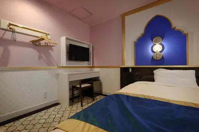 a hotel room with a bed and a tv at Four Stories Hotel Maihama Tokyo Bay in Urayasu
