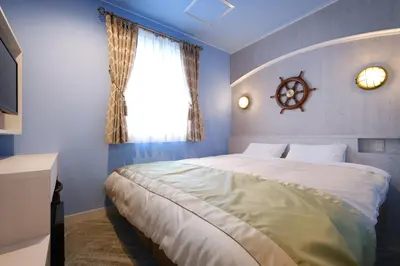 a bedroom with a large bed and a window at Four Stories Hotel Maihama Tokyo Bay in Urayasu
