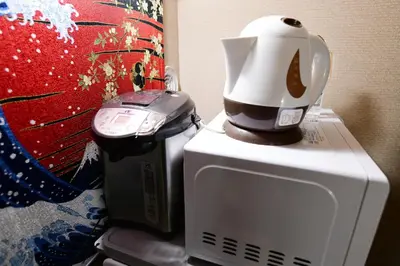 a coffee maker sitting on top of a microwave at Jing House akihabara Ryokan - Vacation STAY 30887v in Tokyo