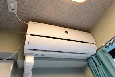 a computer printer in a corner of a room at Jing House akihabara Ryokan - Vacation STAY 30887v in Tokyo