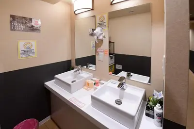 a bathroom with two sinks and a mirror at Jing House akihabara Ryokan - Vacation STAY 11566v in Tokyo