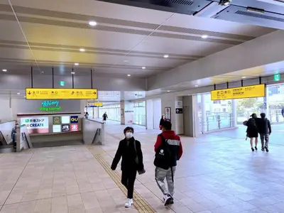 a group of people walking through an airport with a face mask at SKYE HOME in Tokyo