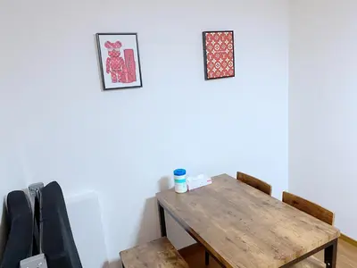 a dining room with a wooden table and chairs at SKYE HOME in Tokyo