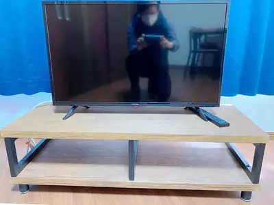 a tv on a wooden stand with a tv on it at SKYE HOME in Tokyo