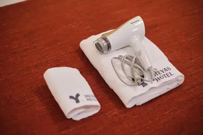 a hair dryer and a towel on a table at TORA HOTEL Tokyo Ueno \u5bc5\u30db\u30c6\u30eb \u4e0a\u91ce A in Tokyo