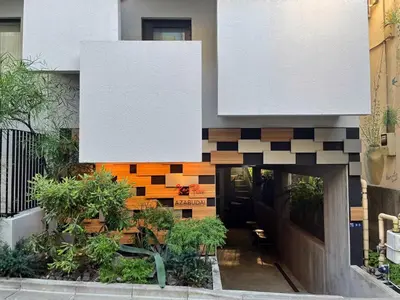 a building with a tile wall and a hallway at Ken's Place Azabudai in Tokyo