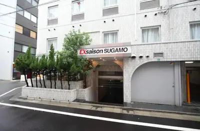 a building with a sign on the front of it at Exsasion Sugamo in Tokyo