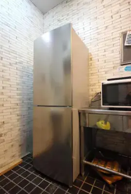 a stainless steel refrigerator in a kitchen at Exsasion Sugamo in Tokyo