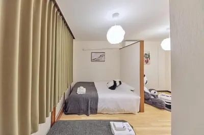 a bedroom with a bed and a large window at TORA HOTEL Tokyo Ueno \u5bc5\u30db\u30c6\u30eb \u4e0a\u91ce B in Tokyo