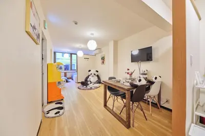 a dining room with a table and two panda bears at TORA HOTEL Tokyo Ueno \u5bc5\u30db\u30c6\u30eb \u4e0a\u91ce B in Tokyo