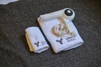 a hair dryer sitting on top of a towel at TORA HOTEL Tokyo Ueno \u5bc5\u30db\u30c6\u30eb \u4e0a\u91ce B in Tokyo