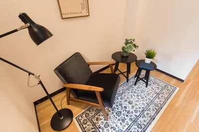 a living room with a chair and a lamp at TORA HOTEL Tokyo Ueno \u5bc5\u30db\u30c6\u30eb \u4e0a\u91ce C in Tokyo