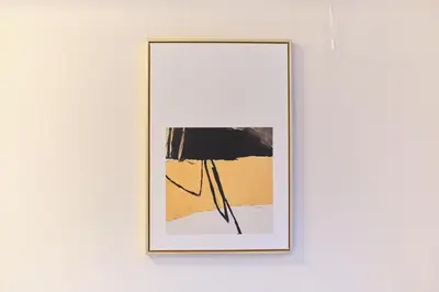 a framed picture hanging on a wall in a room at TORA HOTEL Tokyo Ueno \u5bc5\u30db\u30c6\u30eb \u4e0a\u91ce C in Tokyo