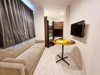 a living room with a couch and a table at PRISM INN Asakusa in Tokyo