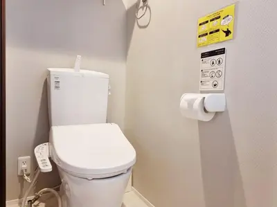 a bathroom with a white toilet in a room at PRISM INN Asakusa in Tokyo