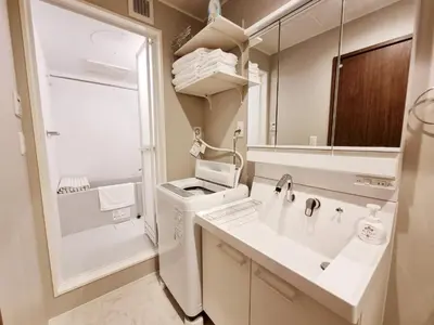 a bathroom with a sink and a large mirror at PRISM INN Asakusa in Tokyo
