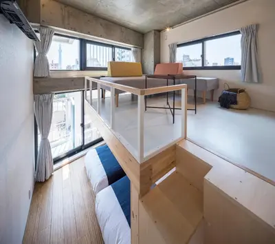 a living room with a couch and a table at dots. tokyo in Tokyo