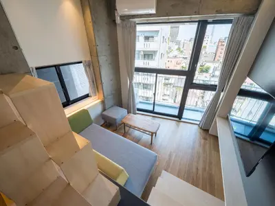 a living room with cardboard boxes and a couch at dots. tokyo in Tokyo