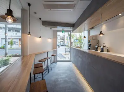 a bar with a row of stools and tables at dots. tokyo in Tokyo