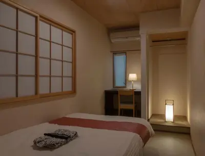 a bedroom with a bed and a desk and a window at belle via tokyo - Vacation STAY 32426v in Tokyo
