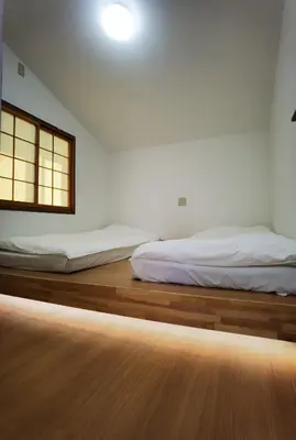 two beds sitting on a wooden floor in a room at belle via tokyo - Vacation STAY 32425v in Tokyo