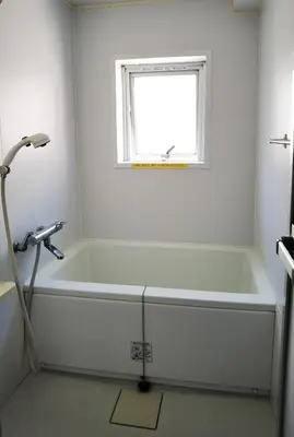 a white bath tub in a bathroom with a window at belle via tokyo - Vacation STAY 32425v in Tokyo