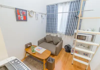 a small living room with a couch and a table at japan house Ikebukuro in Tokyo