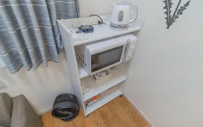 a small white shelf with a tv on it at japan house Ikebukuro in Tokyo