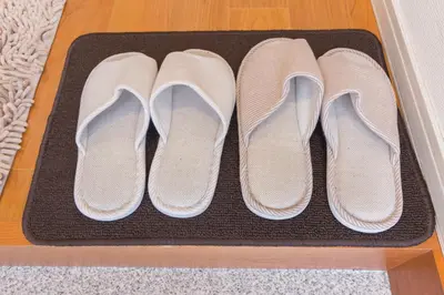 three pairs of shoes sitting on a mat on the floor at japan house Ikebukuro in Tokyo